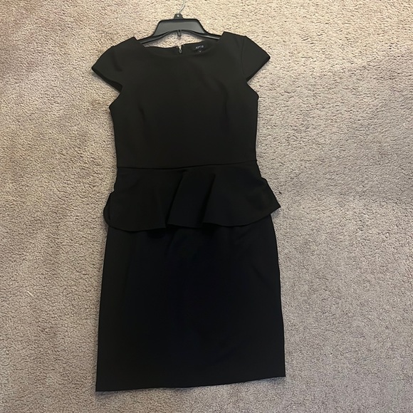 A black formal dress that is very plain and simple. Can be dressed up or down. - Picture 1 of 3